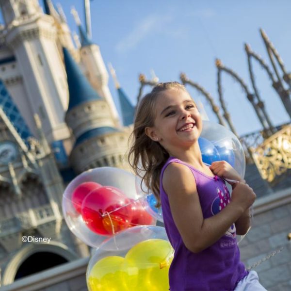 Girl with balloons at Magic Kingdom