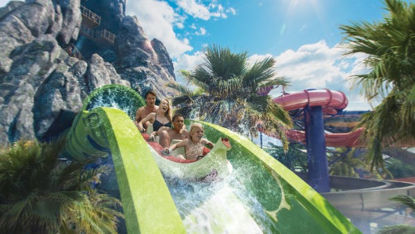 Family riding a water slide at Universal's Volcano Bay water theme park